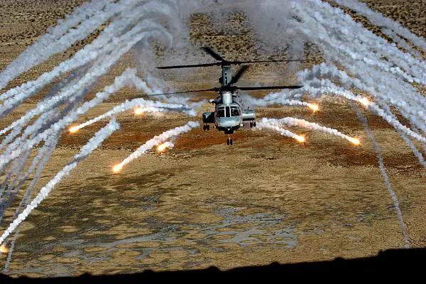 Photo of the Boeing Seaknight deploying flares while flying.
