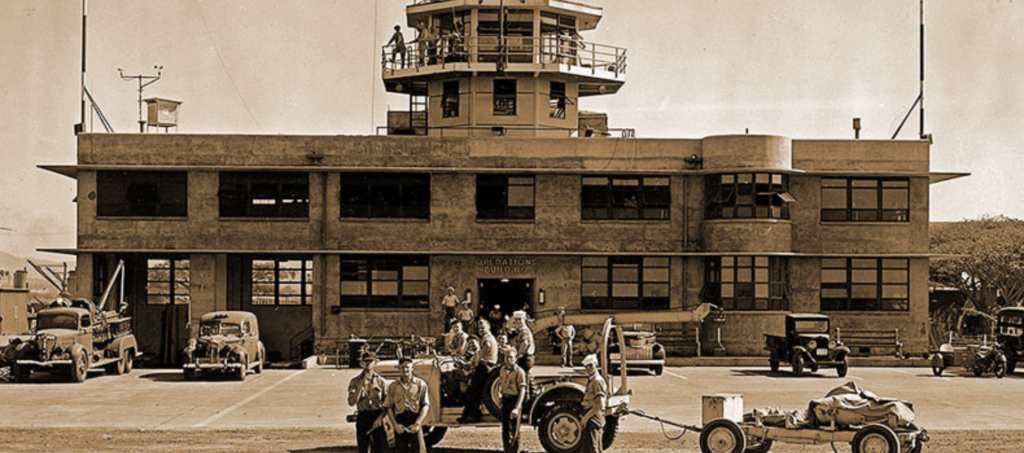 Original photograph of the Ford Island Control Tower with crew posed out front.