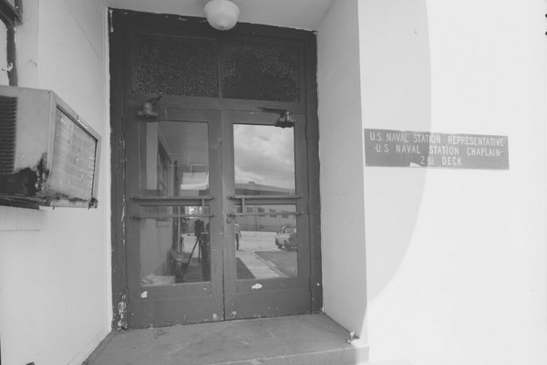 Black and white photograph of Ford Island Control Tower's exterior side-entry double doors.