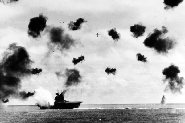 Black and white photograph of the USS Yorktown (CV-5) is hit on the port side, amidships, by a Japanese Type 91 aerial torpedo during the mid-afternoon attack by planes from the carrier Hiryu,