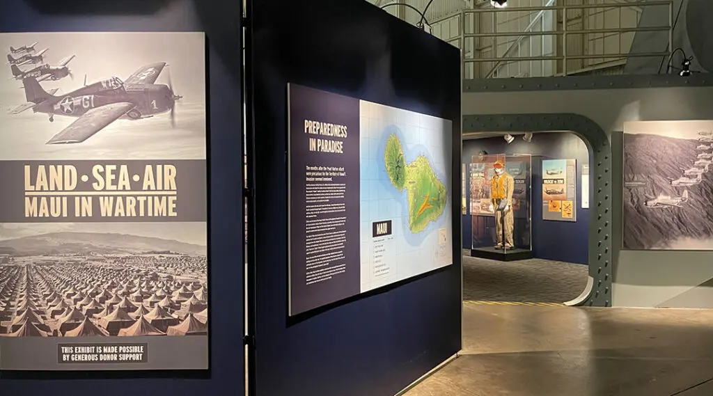 Photograph of museum exhibit featuring photos and plaques.