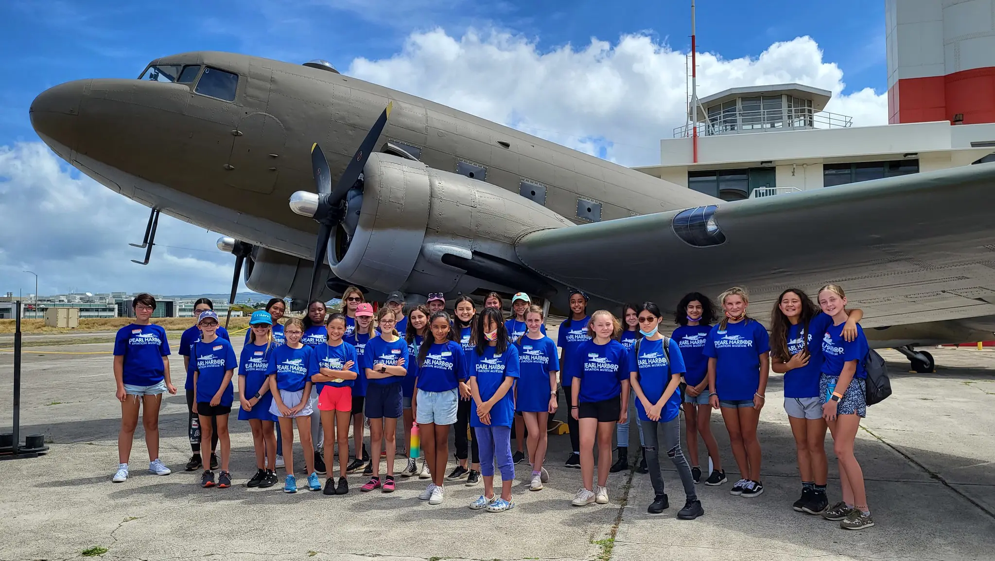 Summer Camp Girl Class posing in front of aircraft.