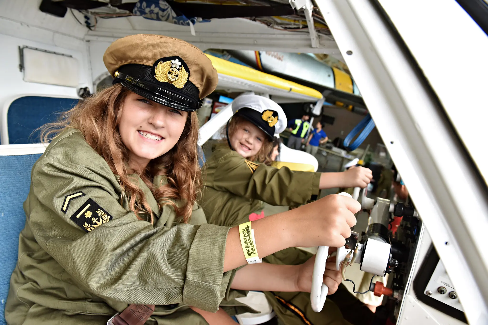 Kids sitting inside of an airplane