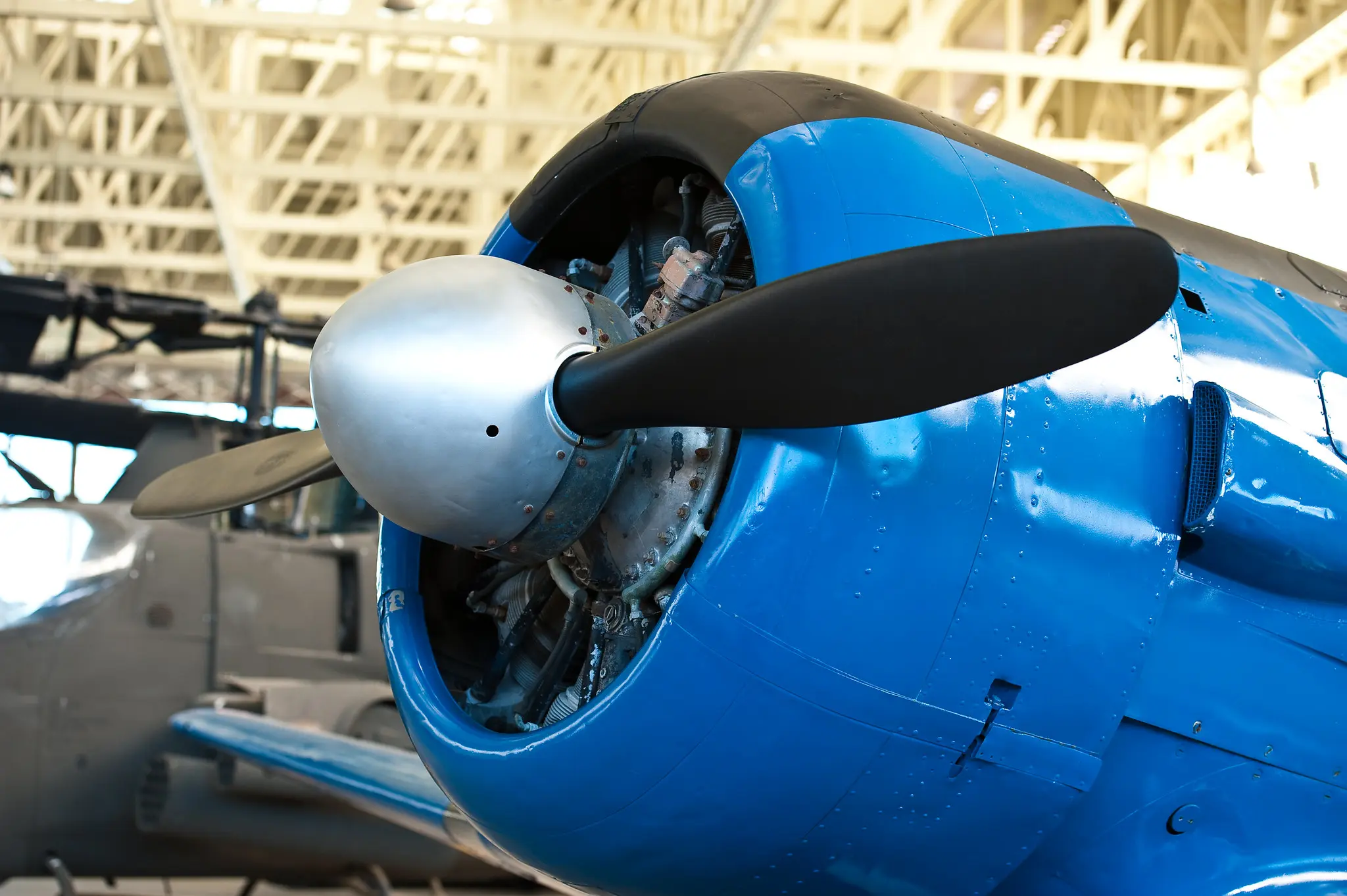 closeup photo of propellar on plan inside of airplane hangar