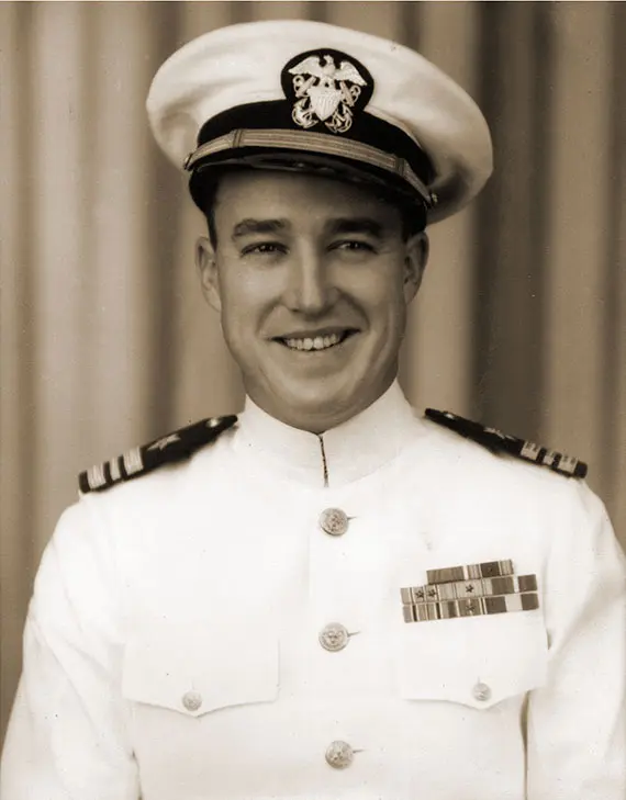 Vintage photograph of a young Lieutenant Jack Sheretz smiling and wearing a decorated white uniform