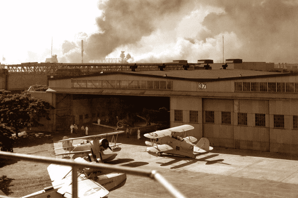 Untitled design (16) Historic Hangar 37 during the December 7, 1941 attack on Pearl Harbor.