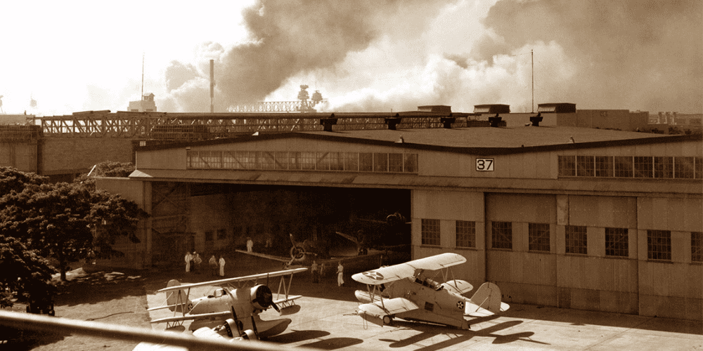 Untitled design (25) Historic Hangar 37 during the December 7, 1941 attack on Pearl Harbor.