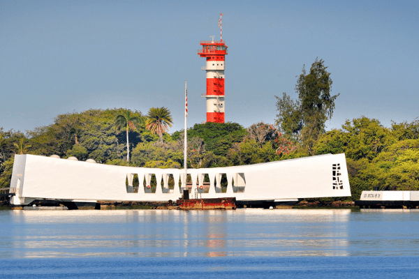 Untitled design (28) The USS Arizona Memorial with the Ford Island Control Tower behind.