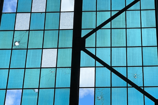 Bullet holes in windows of Hangar 79.