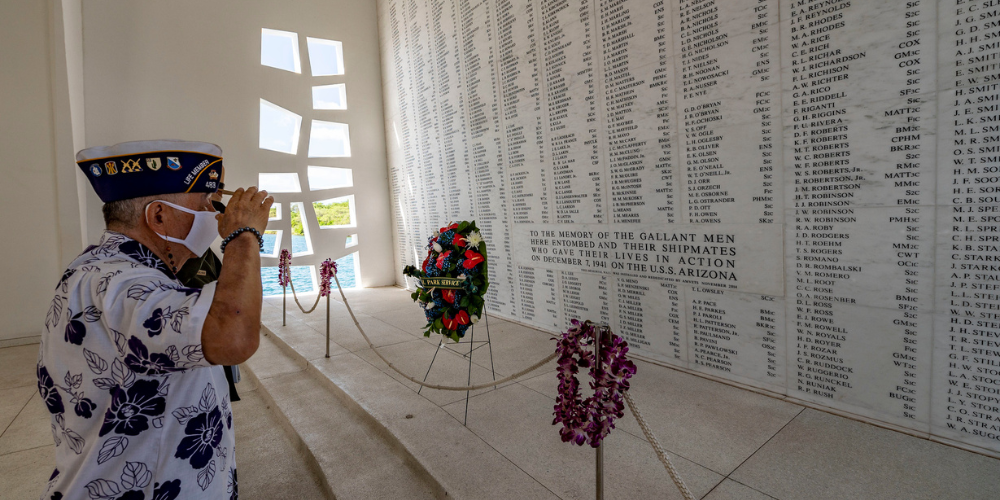 Henry Lee, a Pearl Harbor survivor and U.S. Army Veteran renders honors in the USS Arizona shrine room. 