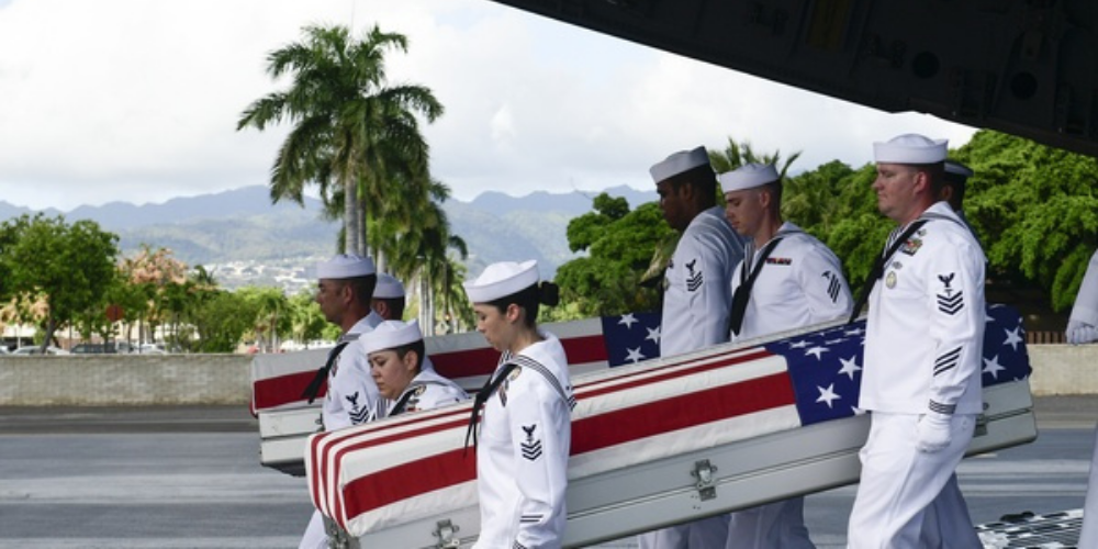 United States Navy Sailors carrying remains of USS Oklahoma Sailors and Marines. 