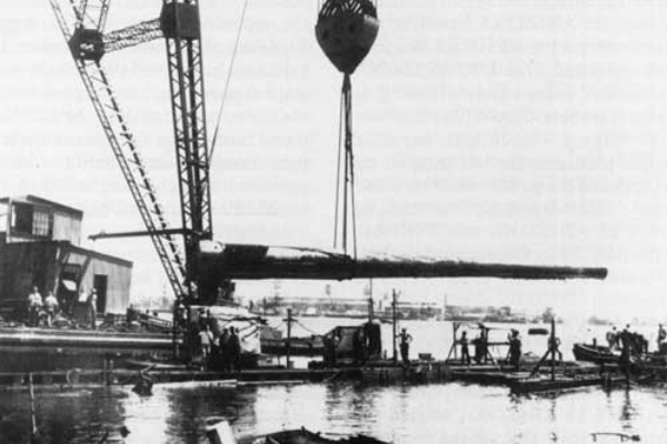 Gun turrets being removed from the USS Arizona shortly after the attack.