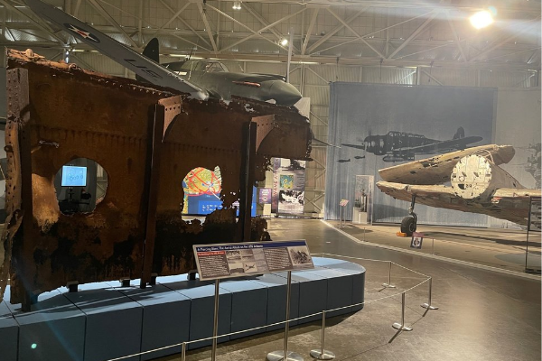 The USS Arizona relic on display with Japanese Kate aircraft in view in historic Hangar 37.