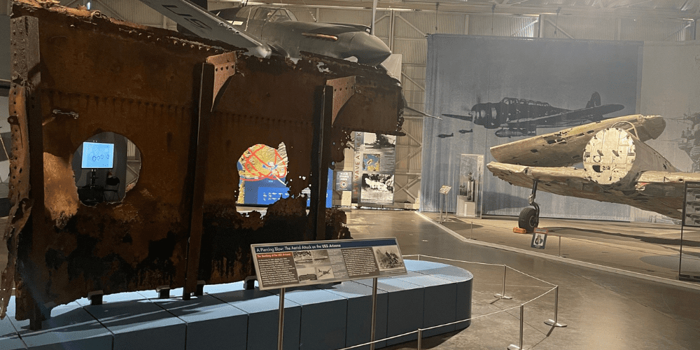 Untitled design (38) The USS Arizona relic on display with Japanese Kate aircraft in view in historic Hangar 37.