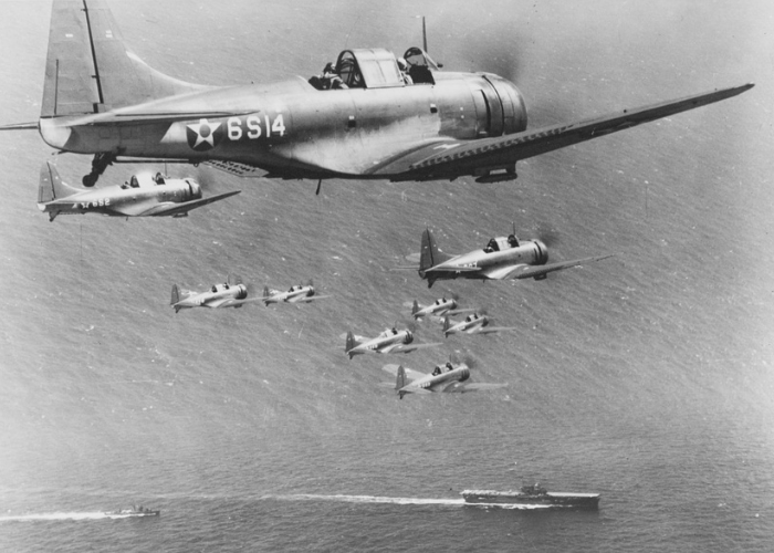 U.S. Navy Douglas Dauntless SBD-2 of Scouting Squadron 6 (VS-6) in
flight with the aircraft carrier USS Enterprise (CV-6) and destroyer below.