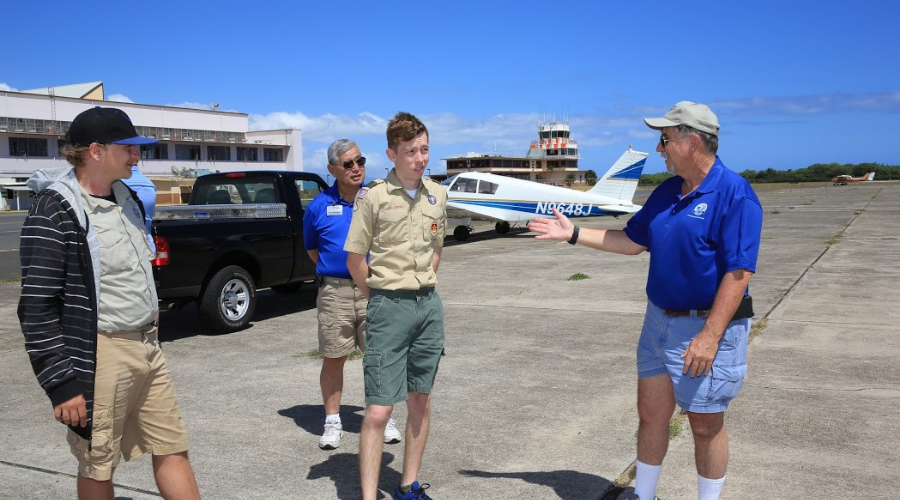 Boy Scouts participating in Pearl Harbor Aviation Museum's Aviation Merit Badge program with volunteer Bruce Mayes.