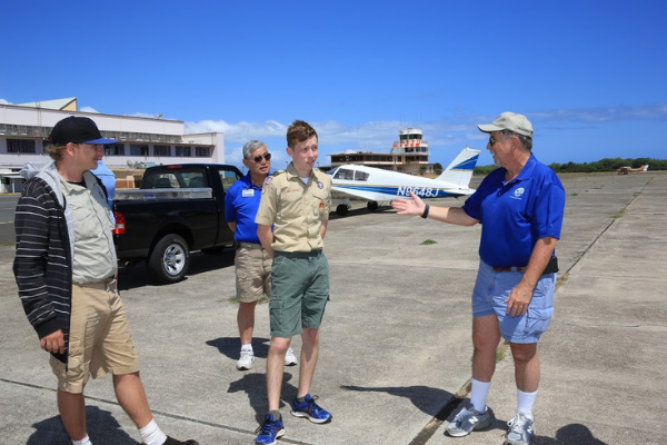 Boy Scouts participating in Pearl Harbor Aviation Museum's Aviation Merit Badge program with volunteer Bruce Mayes.