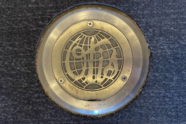 Historic elevator medallion bearing 1940s OTIS logo.