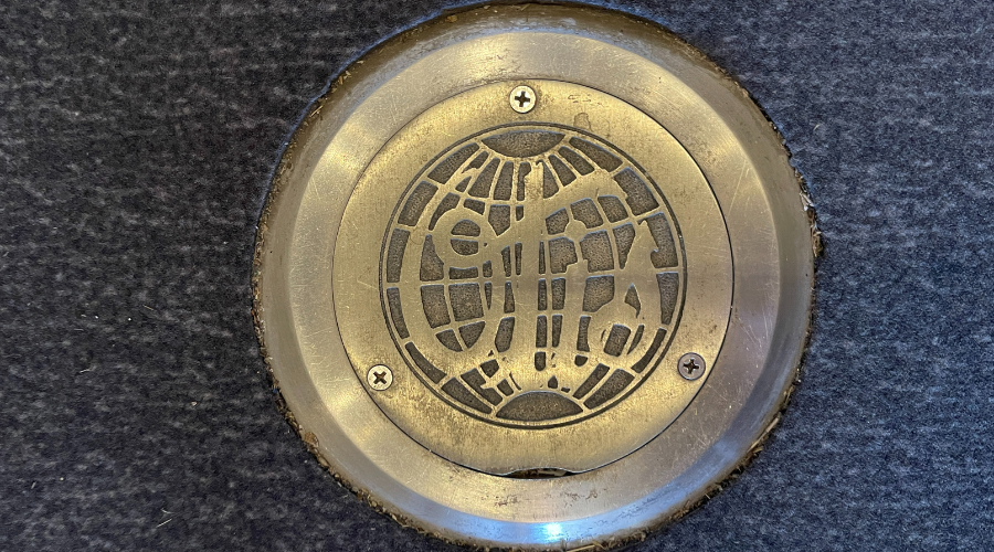 Historic elevator medallion bearing 1940s OTIS logo.