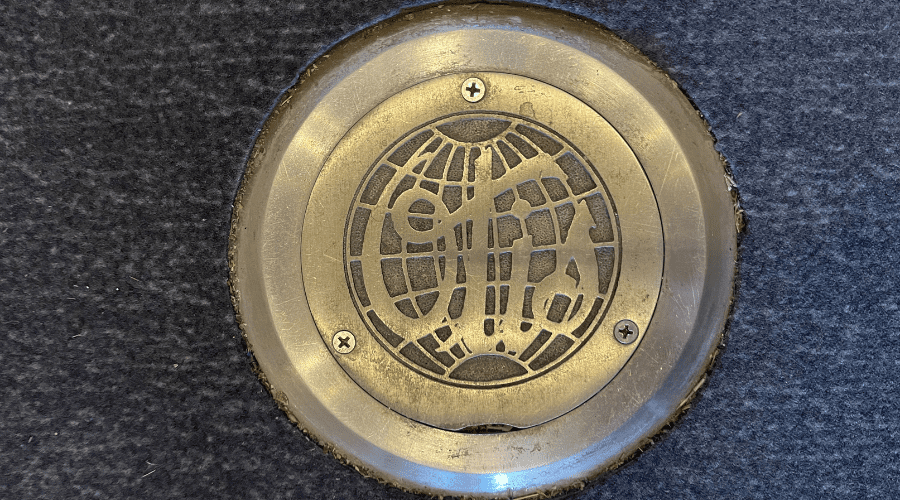 Elevator Blog Desktop Historic elevator medallion bearing 1940s OTIS logo.